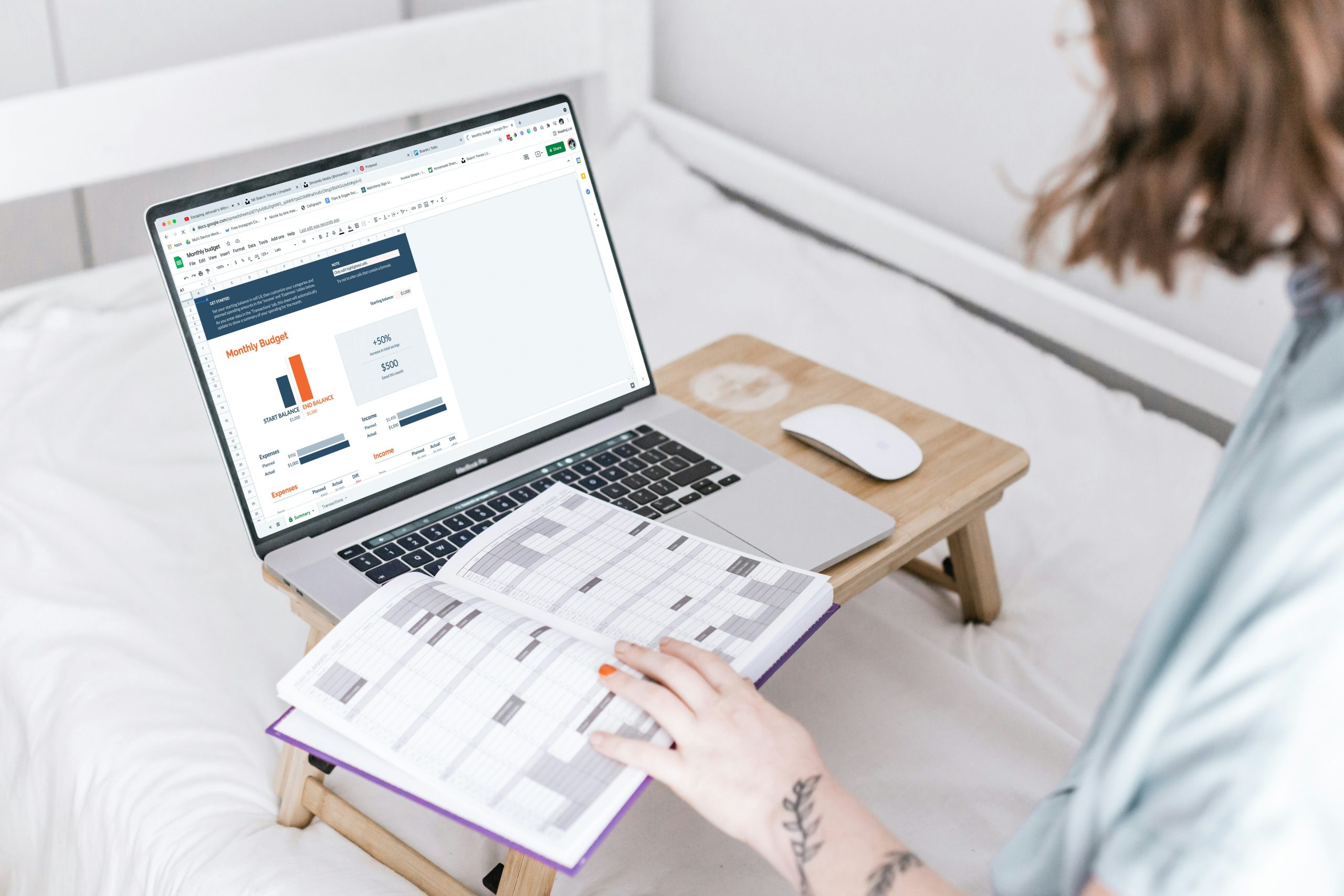 Person working on laptop with planner